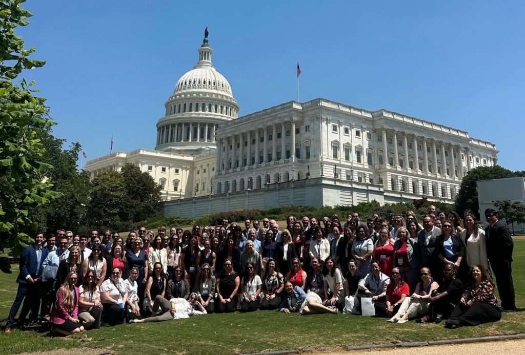 Large group posing in front of the United States Capitol building in Washington, D.C.